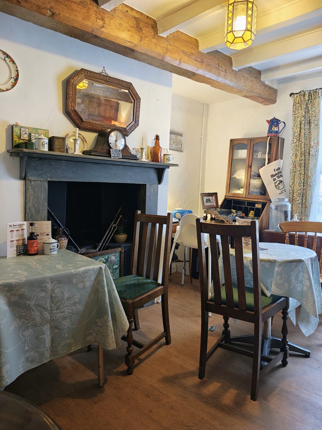 Inside Humble Pie n Mash: tables by the fireplace