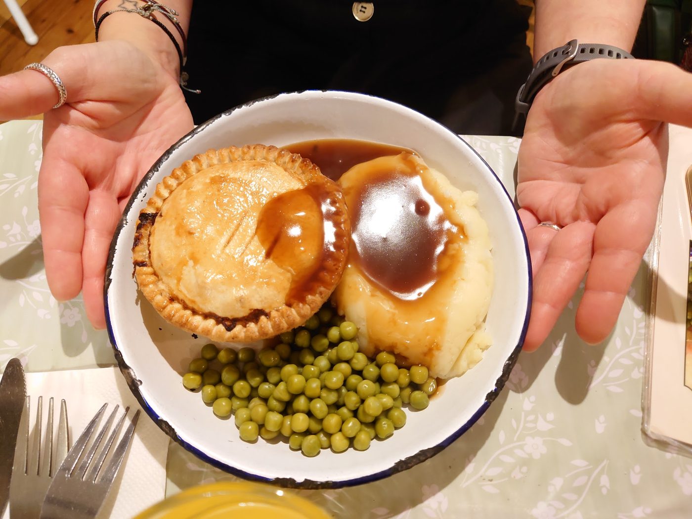 Pie and mash with peas, held up to the camera